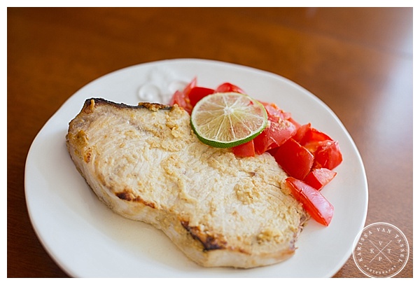 Food photo featuring a swordfish steak with garlic and tomatoes