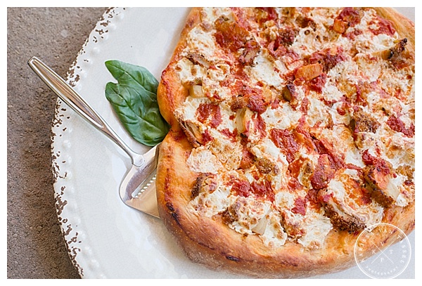 Food photography featuring a homemade pizza topped with grilled chicken and mozzarella