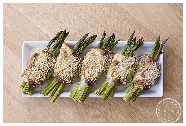 Food photo featuring asparagus spears wrapped in proscuitto